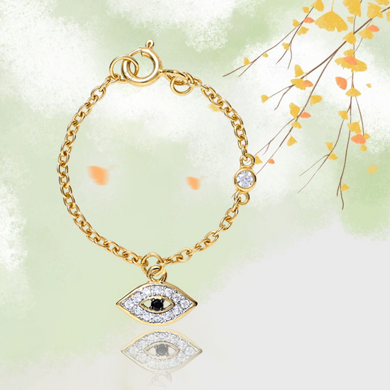 Evil eye watch charm in 14 kt yellow gold with diamond and onyx in the center