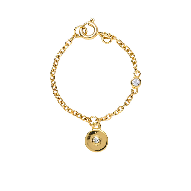 Circular watch charm in 14kt gold and bazel set diamond in center